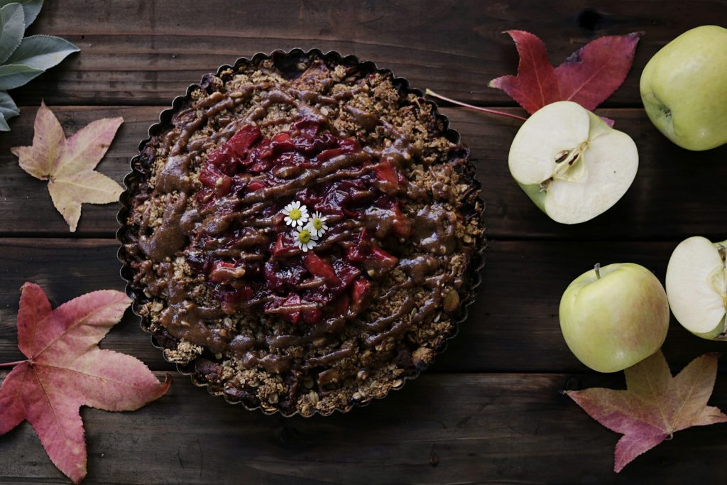 baked pastry on brown wooden surface beside sliced apples